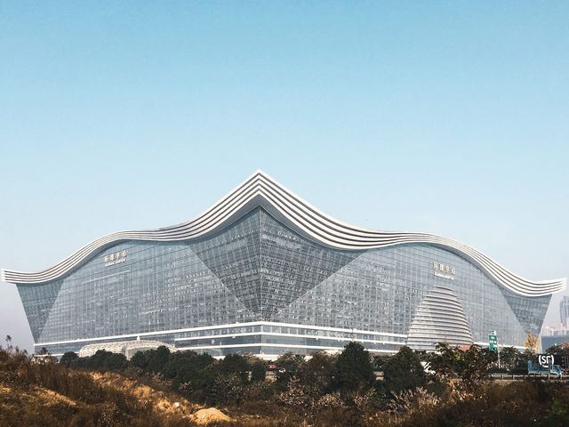 The curved wave-shaped glass roof of the New Century Global Center, seen from the plaza