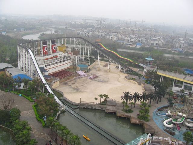 An aerial view over the rides, lake and lawns of Happy Valley Chengdu
